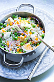 Rice salad with young peas, eggs and cardamom for a picnic
