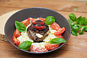 Minced meat steaks with mozzarella served with farfalle and a tomato salad