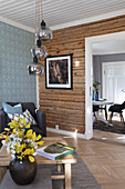 Wooden wall in living room with open doorway leading into dining room