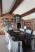 Rustic dining room with open fireplace and exposed ceiling beams