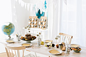 Table set for child's birthday party with world travel motif