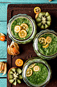 Green smoothie with spinach, kiwi, spirulina and kumquat