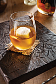 Vermouth and bourbon coacktail with ice cube