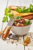From above appetizing colorful cut vegetable mix with spinach lentils and rice on wooden background
