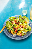 Summer salad with griled hallumi, nectarines, pine nuts and lettuce leaves