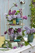 Small bouquets with lilac flowers on a cake stand