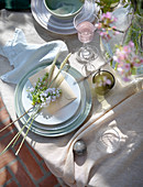 Flowers, cereal ears and envelope on plate on set table