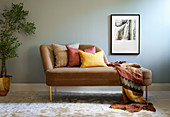 Spice shades: Cushions and blanket on chaise in warm colours