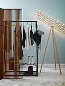 Coat rack and standard lamp behind screen