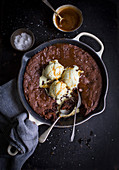 Chocolate skillet cookie with vanilla ice cream and salted caramel sauce