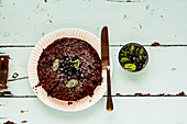 Chocolate blueberry crumble cake on turqouise background