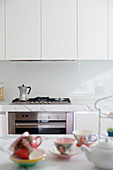 Espresso pot on gas cooker in white, modern kitchen