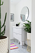 View into bathroom with classic washstand and houseplants