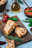 Mediterranean scones with spicy tomato spread on a wooden board
