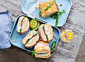 Baguette sandwiches with meatloaf, horseradish, cream cheese and arugula in a lunchbox