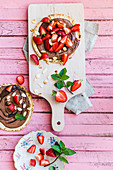 Strawberry pancakes with chocolate cream and almond flakes
