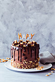 Peanut chocolate cake decorated with the word 'Happy'