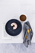 Marble donut with white icing, served with coffee