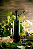 A bottle of white wine on a wooden background