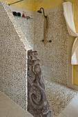 Shower area with pebble mosaic tiles