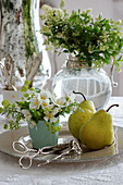 Posy of summer jasmine, pears and pastry tongues on silver platter