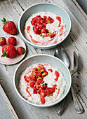 Rice pudding with strawberries, pistachios and strawberry sauce