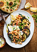 Grilled aubergine with chickpeas and naan bread