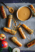 Baklava rolls with pistachios and caramel sauce