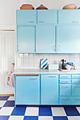 Pale blue retro kitchen with blue-and-white chequered floor
