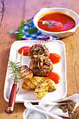 Grilled meatballs with feta cheese served with grilled potatoes and pumpkin-BBQ sauce