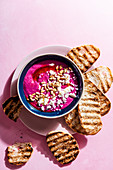 Whipped feta and beetroot dip with pine nuts and olive oil