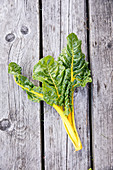 Yellow chard on a wooden surface