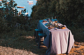 A table laid with seafood and wine by the sea
