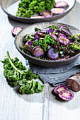 Baked purple potatoes with kale