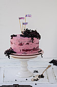 An elderberry cake on a cake stand