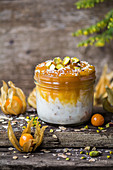 Coconut yoghurt with oats, physalis jam and pistachio nuts