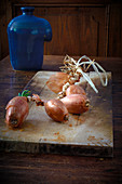 Shallots on a rustic wooden board