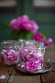 Pink roses in screw-top jars