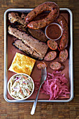 Meat platter with corn bread coleslaw and red onion