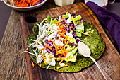 A gluten-free salad burrito being made