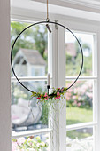 Nordic flower wreath hung in window