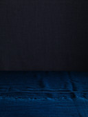 Dark blue fabric as backdrop and a black background