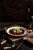 Beetroot carpaccio with arugula, feta cheese and italian nuts