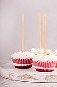 Strawberry ice cream popsicle lollies with whipped cream frozen in muffin molds