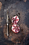 Halves pomegranate and knife