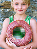Girl holding round bread