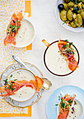 Soup with ham and cress, and a bowl of marinated olives