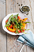 Autumnal rocket salad with pumpkin