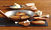 Toasted bread with garlic in a pan (Topinky, Czech Republic)