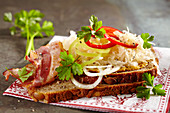 Wholewheat bread with mustard, sauerkraut, bacon, onion and peppers